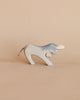 A handcrafted Ostheimer Donkey - Stubborn, painted light blue with visible wood grain, posed against a plain beige background. The donkey has small white ears and a thin tail.