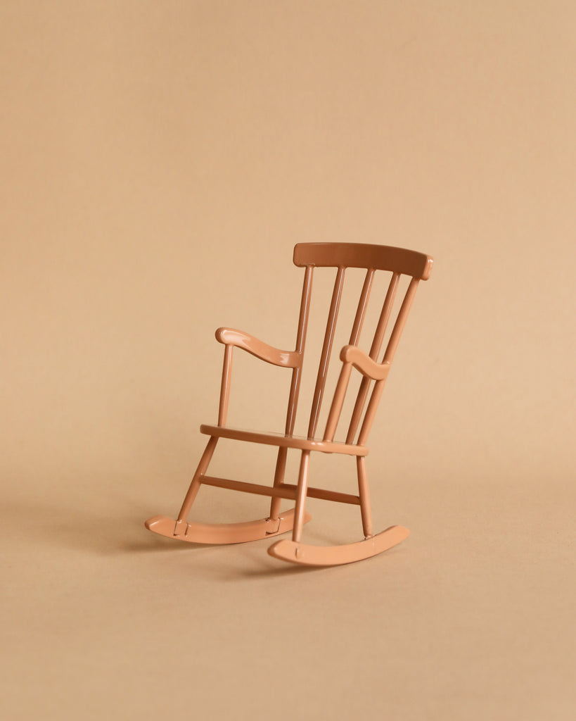 The Maileg Nursery Set features a small wooden rocking chair with curved rockers, perfect for a Maileg Mouse, displayed on a beige surface against a matching beige background.