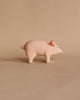 The Handmade Wooden Pig figurine features a round body, short tail, and upward-facing snout with child-safe paint, set against a plain beige background for a minimalist aesthetic.