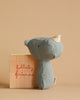 A small, green stuffed animal with polka dot ears stands by a "lullaby friends" box on a beige background. Made from organic cotton, it's perfect as a baby gift or for newborn accessories in the Newborn Gift Set.