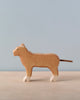Noah's Ark With Animals, a Holztiger wooden toy set, features a lioness carved in solid wood and painted in natural tones with white feet, displayed against a light blue background, showcasing exceptional craftsmanship.