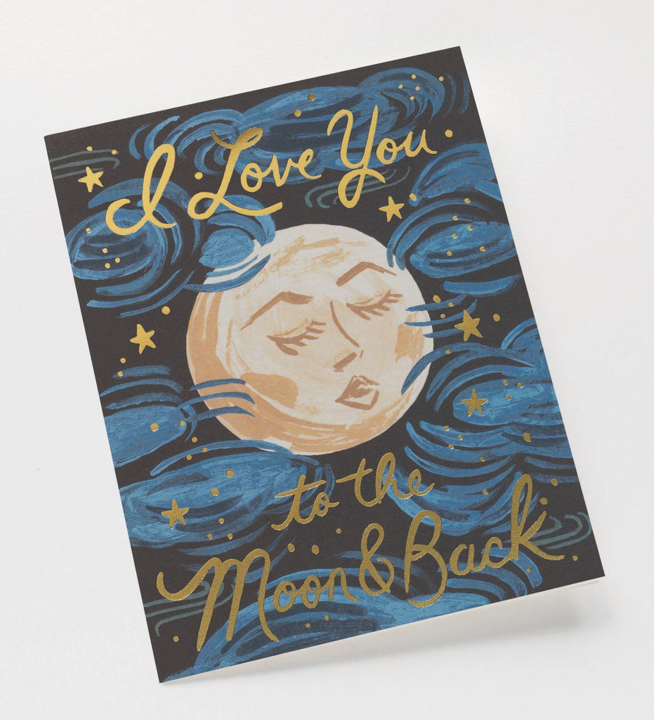 The To the Moon and Back Card features an illustrated moon face with blue and metallic gold foil stars and clouds. "I love you to the moon & back" is written in gold script on a black background. The blank interior awaits your message.