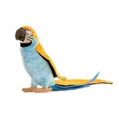 The Parrot Stuffed Animal features a handmade vibrant blue body, yellow accents on the wings and head, and a long tail. Its intricately patterned beak highlights artisanal craftsmanship, allowing it to stand upright elegantly.