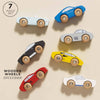 Seven Classic Wooden Sports Cars made from FSC-certified wood are displayed on a light background. The "7 piece set" text emphasizes the colorful, uniquely shaped cars with wooden wheels, designed for train track compatibility.