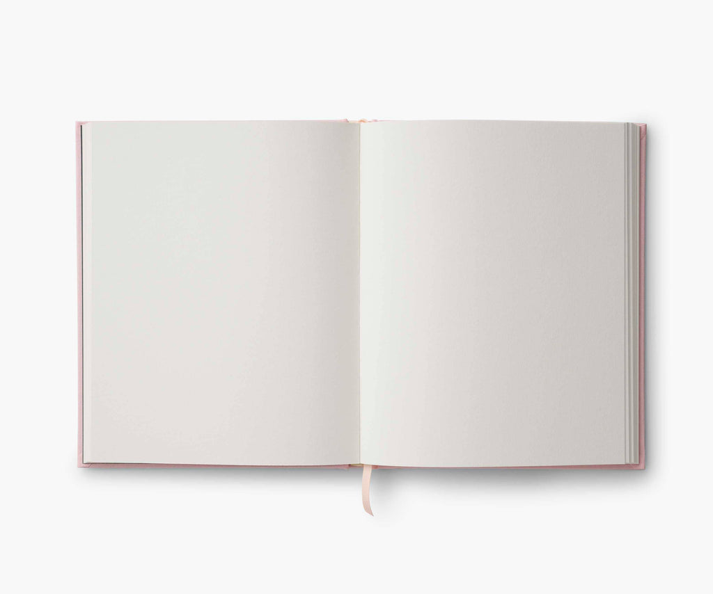 The Menagerie Embroidered Sketchbook is an open hardcover journal with blank white pages and a cream ribbon bookmark, shown from above on a plain white background.