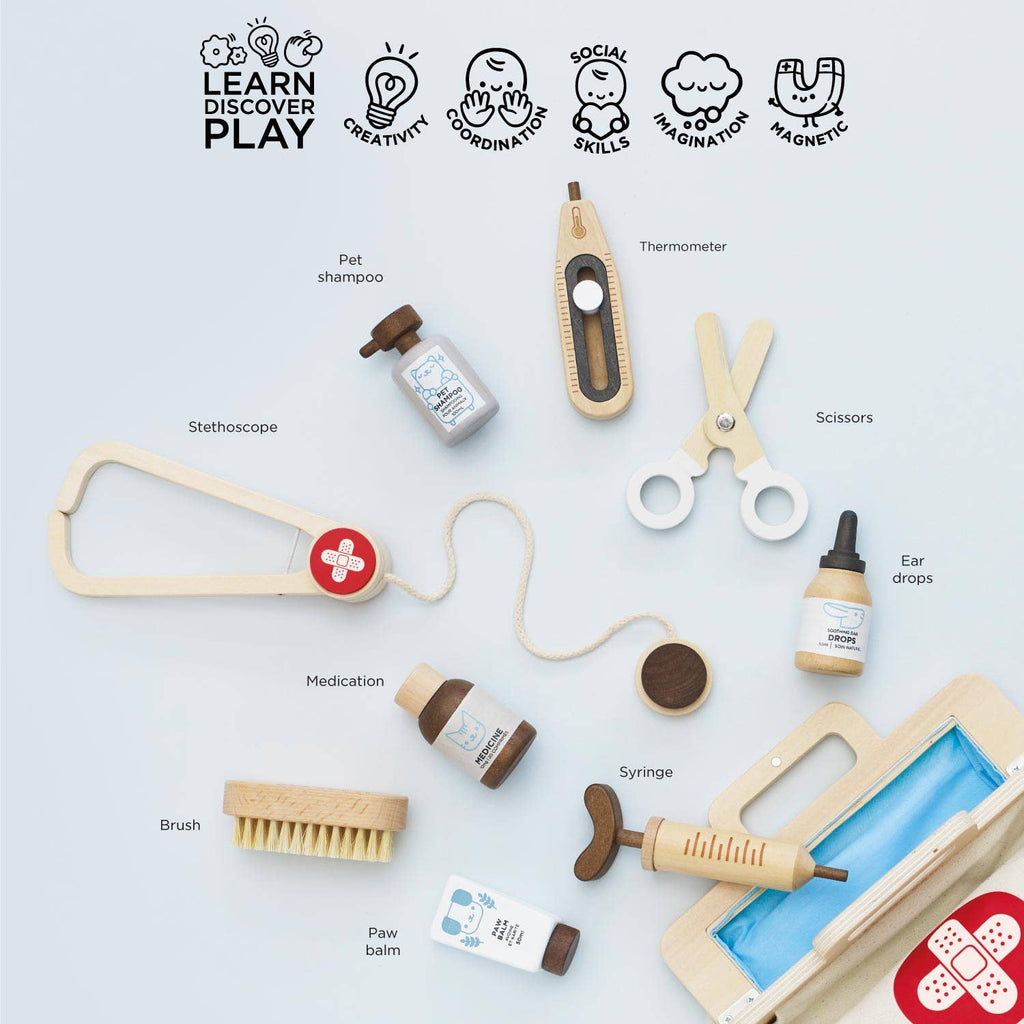 A flat lay of the Pretend Play Animal Vet Set, featuring a stethoscope, thermometer, scissors, and more. Icons above highlight skills gained through veterinarian-inspired role play.