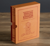 The Jenga Vintage Bookshelf Edition stands upright on a wooden surface in its orange box, featuring minimalist line art of the classic game—an ideal piece to enhance your family game night display.
