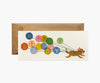 The Balloon Birthday No. 10 Card features a playful dog running with strings attached to colorful balloons spelling out "Happy Birthday" in gold foil, comes with a brown envelope, and has a blank interior for your message.