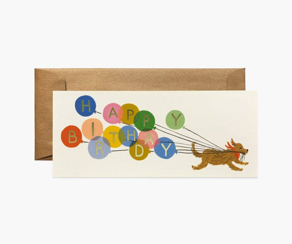 The Balloon Birthday No. 10 Card features a playful dog running with strings attached to colorful balloons spelling out "Happy Birthday" in gold foil, comes with a brown envelope, and has a blank interior for your message.