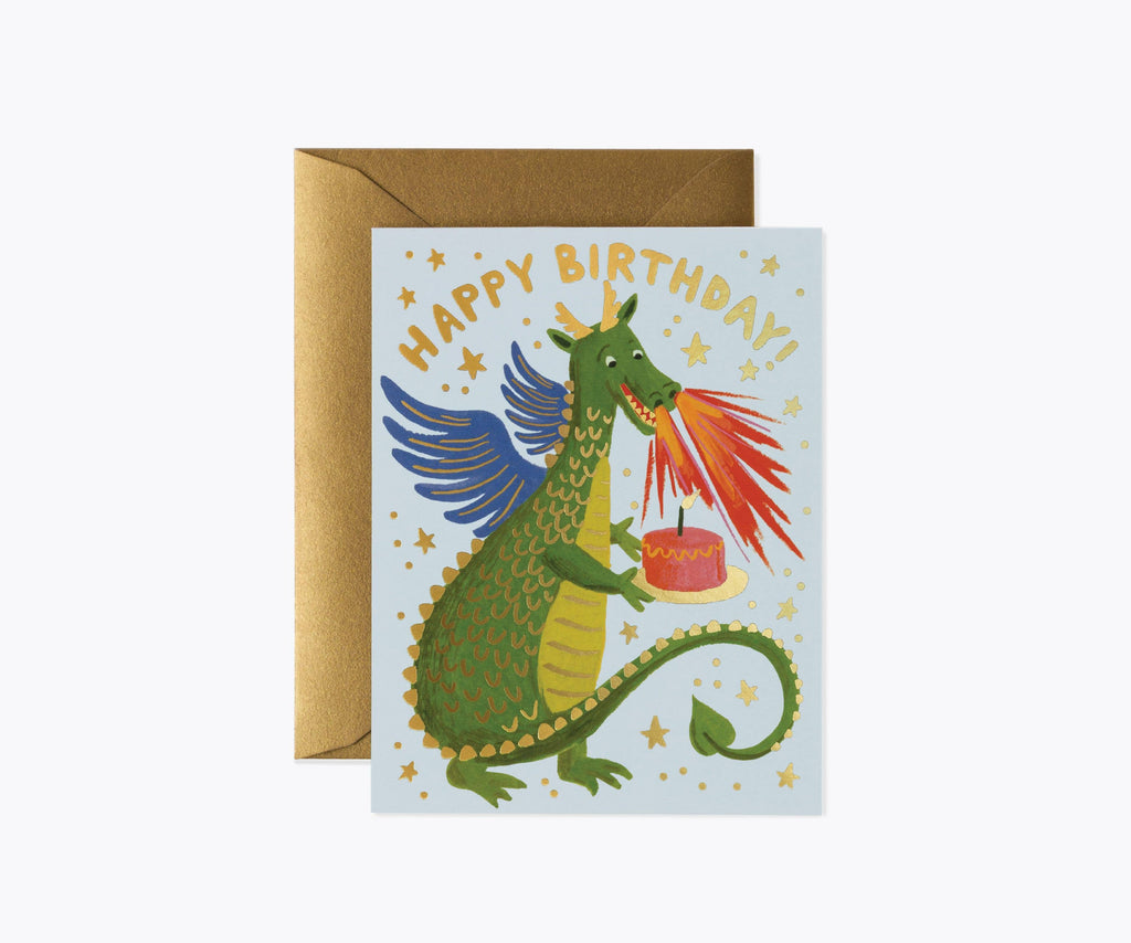 The Birthday Dragon Card features a green dragon breathing fire onto a cake, metallic gold foil stars, and "Happy Birthday!" above. The blank interior lets you add your own message. Comes with a brown envelope.