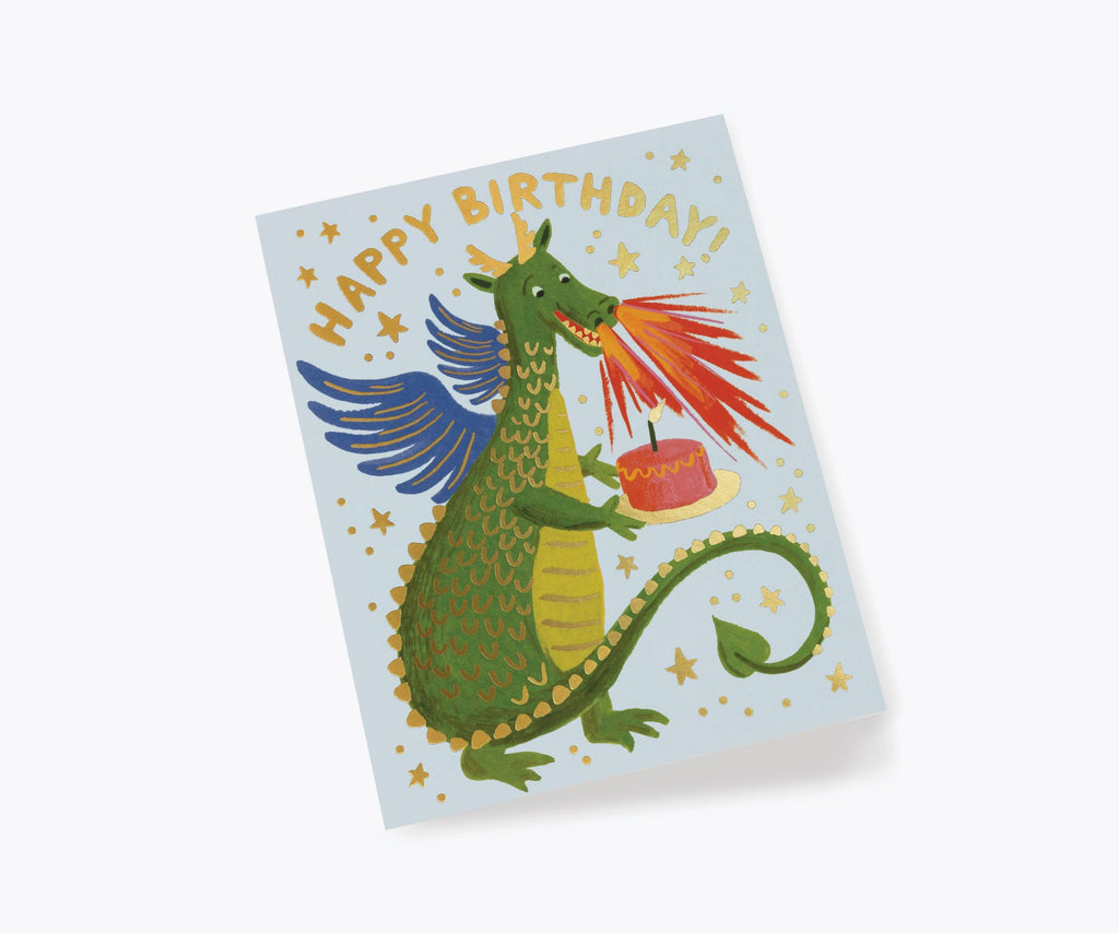 The Birthday Dragon Card features a green dragon breathing fire at a cake, surrounded by stars. "HAPPY BIRTHDAY!" shines in metallic gold foil at the top. Blank inside for your message.