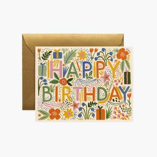 The Fiesta Birthday Card features "HAPPY BIRTHDAY" in bold letters with colorful flowers, leaves, and gifts, paired with a metallic gold envelope—ideal for adding your handwritten note inside.