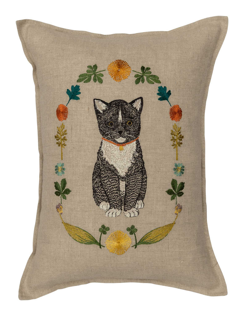 Introducing the Coral & Tusk Kitten Cameo Pillow, a decorative masterpiece showcasing an embroidered black and gray tuxedo cat with a red collar, framed by an oval floral wreath in spring hues on beige fabric—adding elegance to any space. Ships in one week.