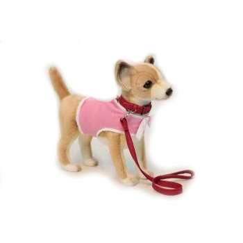 The Chihuahua With Coat & Leash Stuffed Animal, resembling hand-sewn plushies, features a beige and white toy dog in a light pink sweater and red collar with a leash. Set against a white background, it captures the delightful realism of plush animals.