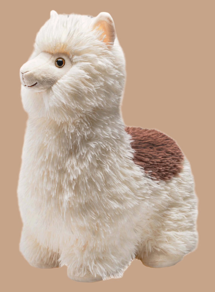 A fluffy Snuggleluvs Alpaca Weighted Stuffed Animal 15" from Wild Republic, featuring a white body with a brown back patch, set against a beige background. It has round eyes and a smiling mouth, making it the ideal cuddle buddy.