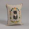 Introducing the Coral & Tusk Kitten Cameo Pillow: A beige cushion adorned with a black and white tuxedo cat with a red collar, surrounded by colorful spring flowers and leaves, on a plain gray background. Ships in one week.