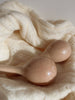 Handmade Wooden Maracas sit on a soft, cream knit blanket under gentle natural light—ideal for babies and toddlers to play with and support developing motor skills.