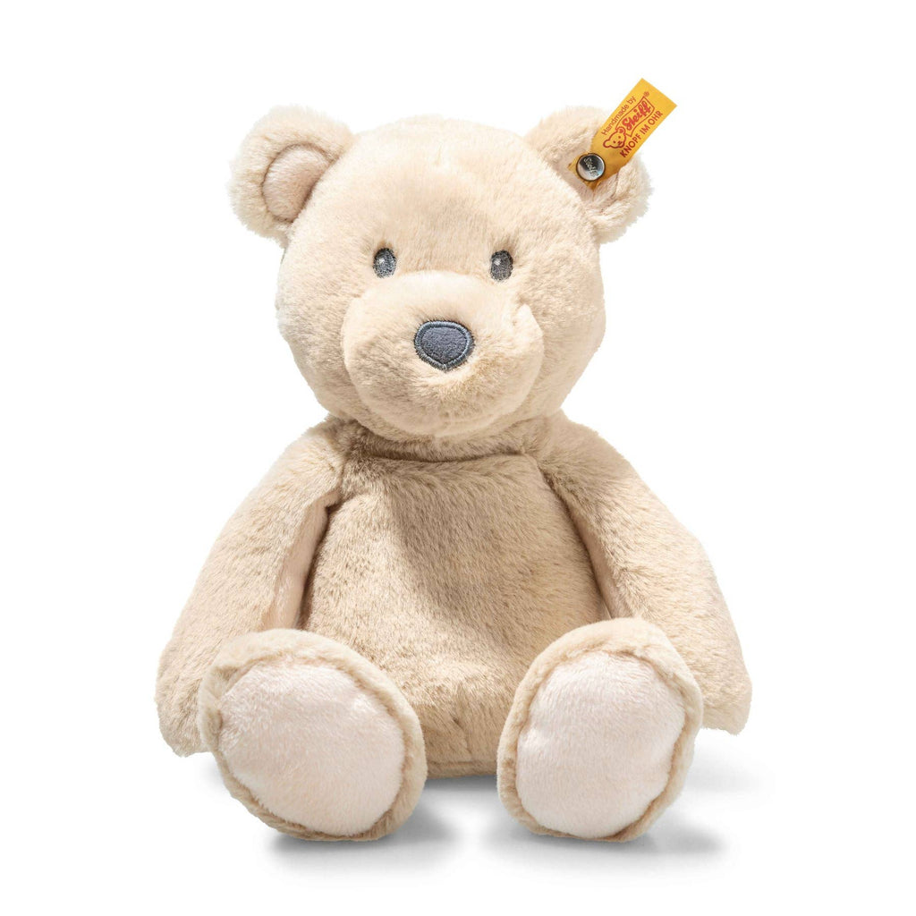 The Steiff Bearzy Teddy Bear is a beige plush companion with a round snout, small ears, and a yellow tag in its left ear, shown sitting upright against a white background.