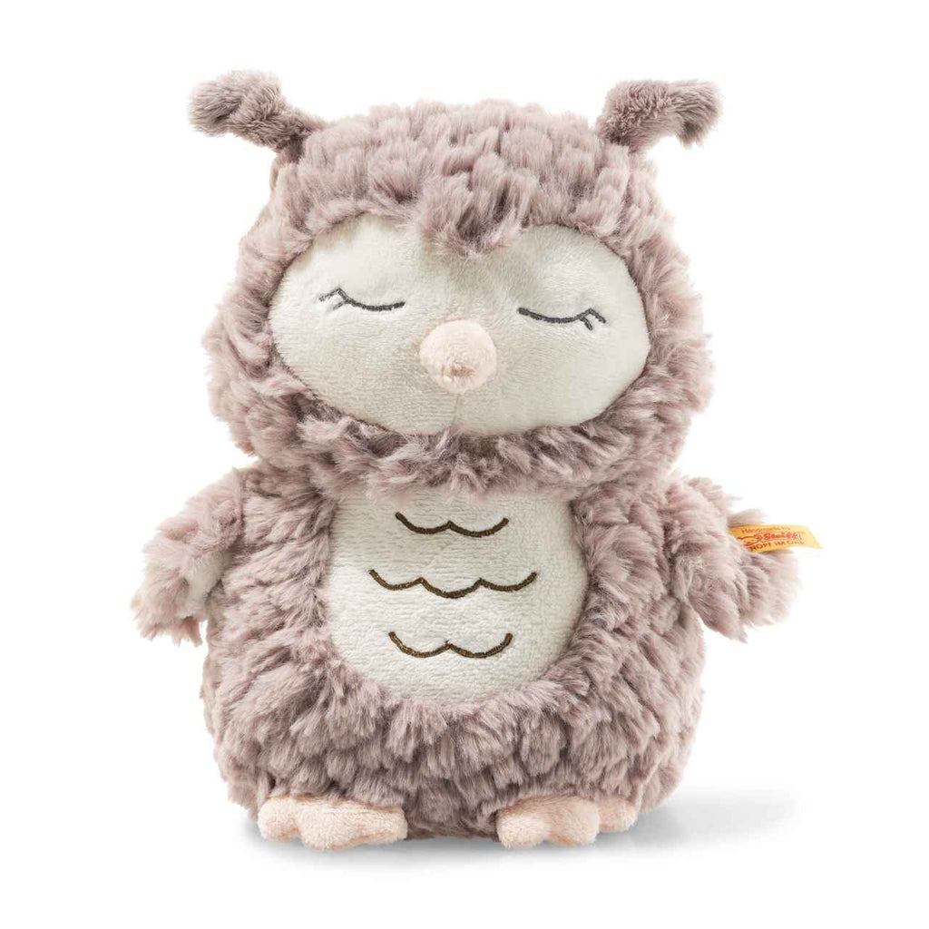 The Steiff Ollie Owl Stuffed Animal is a premium handcrafted plush toy with closed eyes, a light beige face and belly, fluffy light brown fur, small wings, short legs, and embroidered belly details. Soft, cuddly, and perfect for snuggling.