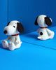 Two Peanuts Snoopy Plush Toys, in a gift box, sit on a vibrant blue background. White with black ears and spots, they have red collars and are positioned sitting and facing different directions, making them perfect additions to any plush collection.
