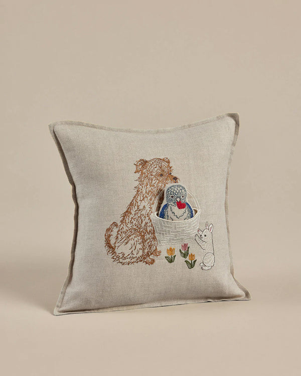 The Coral & Tusk Puppy Love Pocket Pillow features an embroidered design with a dog, a hedgehog in a basket, and a bunny surrounded by colorful flowers. Its charming decorative style makes it perfect as a whimsical Valentine's Day decoration.
