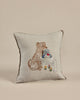 The Coral & Tusk Puppy Love Pocket Pillow features an embroidered design with a dog, a hedgehog in a basket, and a bunny surrounded by colorful flowers. Its charming decorative style makes it perfect as a whimsical Valentine's Day decoration.