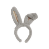 The Olli Ella Fluffle Bunny Headband - Smoke features a fuzzy gray design with two long ears—one upright and the other playfully drooping. The inner side displays a pastel pink floral pattern on white, enhancing its playful appeal.