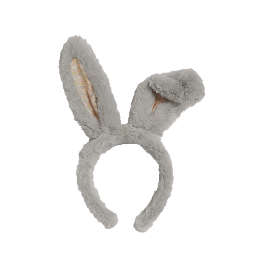 The Olli Ella Fluffle Bunny Headband - Smoke features a fuzzy gray design with two long ears—one upright and the other playfully drooping. The inner side displays a pastel pink floral pattern on white, enhancing its playful appeal.