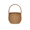 The Olli Ella Gathering Basket, round and woven with a curved handle, stands upright against a white background. Its intricate pattern and natural brown color highlight its timeless elegance and rustic charm.