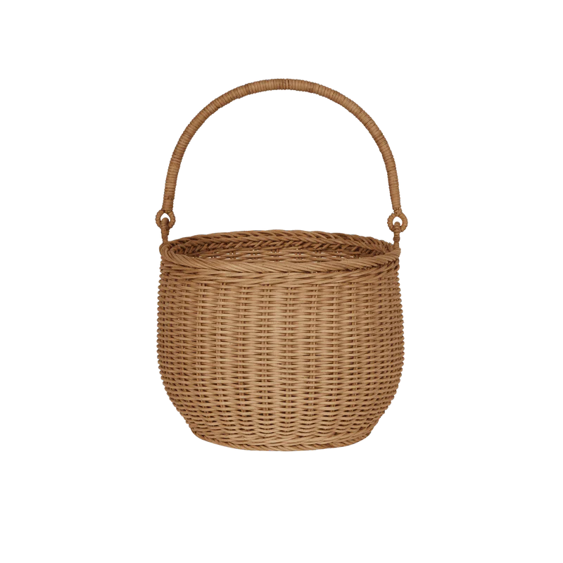 The Olli Ella Gathering Basket, round and woven with a curved handle, stands upright against a white background. Its intricate pattern and natural brown color highlight its timeless elegance and rustic charm.