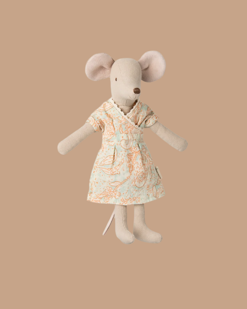 A soft, cuddly Maileg Mum Mouse in a light blue dress with an orange floral pattern is the perfect addition to any charming mouse collection. This PRE-ORDER item, shipping late February, features large ears and a neutral expression against a plain beige background.