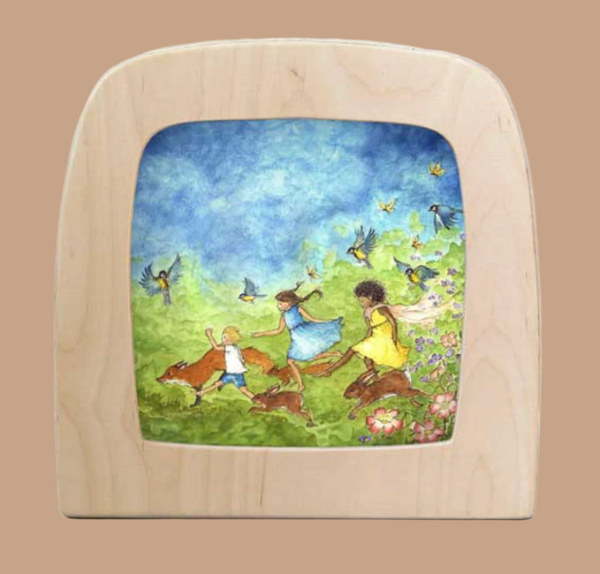 The "Silhouette Only - Spring Race for Toverlux Lamp" features three children running joyfully in a grassy field with birds, butterflies, and bright flowers under a blue sky with scattered clouds, bringing a touch of magic to your home atmosphere.