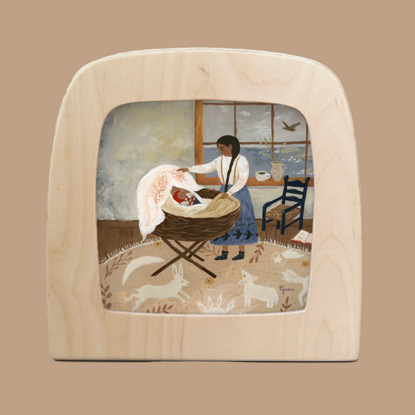 An illustration titled "Silhouette Only - Moment of Tranquility For Toverlux Lamp" depicts a woman in a blue skirt, white blouse tending to a baby in a cradle by a window. A bird casts Magic Silhouettes, with a chair, book, and tea cup accented by an enchanting wooden board. Ships in one week.