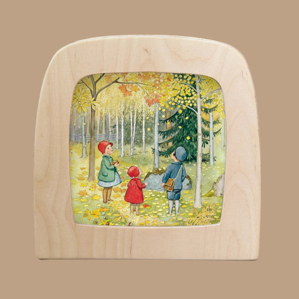 The "Silhouette Only - Around The Year (October) for Toverlux Lamp" features a framed scene of three children in autumn attire exploring a forest with yellow leaves and trees, casting a unique atmosphere against a soft, beige background.