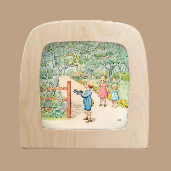 Illustration for "Silhouette Only - Around The Year (September) for Toverlux Lamp" showing three children in a garden. One stands by a wooden gate with a bowl gazing through an enchanting frame, while the others watch in awe. Lush trees and flowers are framed by the arch against a beige background.