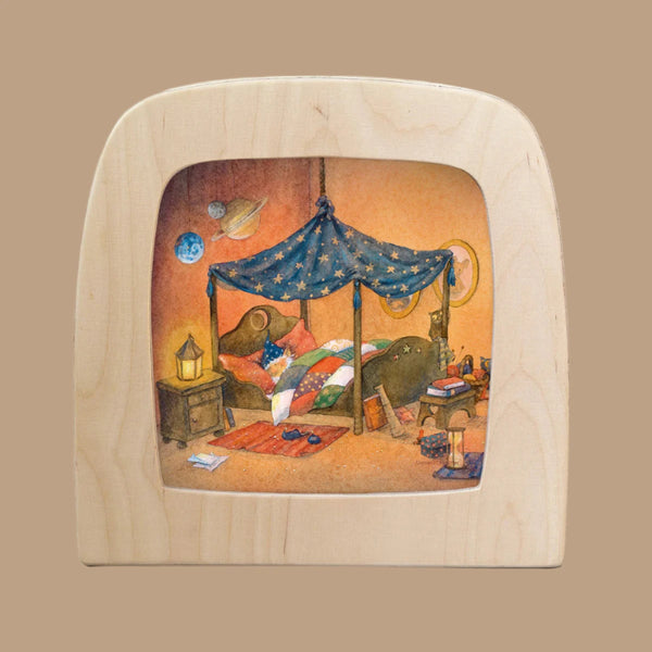 A whimsical illustration features the "Silhouette Only - Goodnight Sandman silhouette - Nighty Night for Toverlux Lamp," showcasing a tent-like bed with a starry canopy, surrounded by planet decor. The cozy setup includes a colorful quilt, warm lantern, slippers, and books, exuding the feel of Magic Silhouettes.