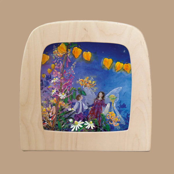 The "Silhouette Only - Little Fairy Can't Sleep Silhouette - Party for Toverlux Lamp" features fairies with wings among vibrant flowers and leaves in a magic window frame. The deep blue background resembles a night sky, enhanced by bright orange flowers above to create a contrasting magical scene.