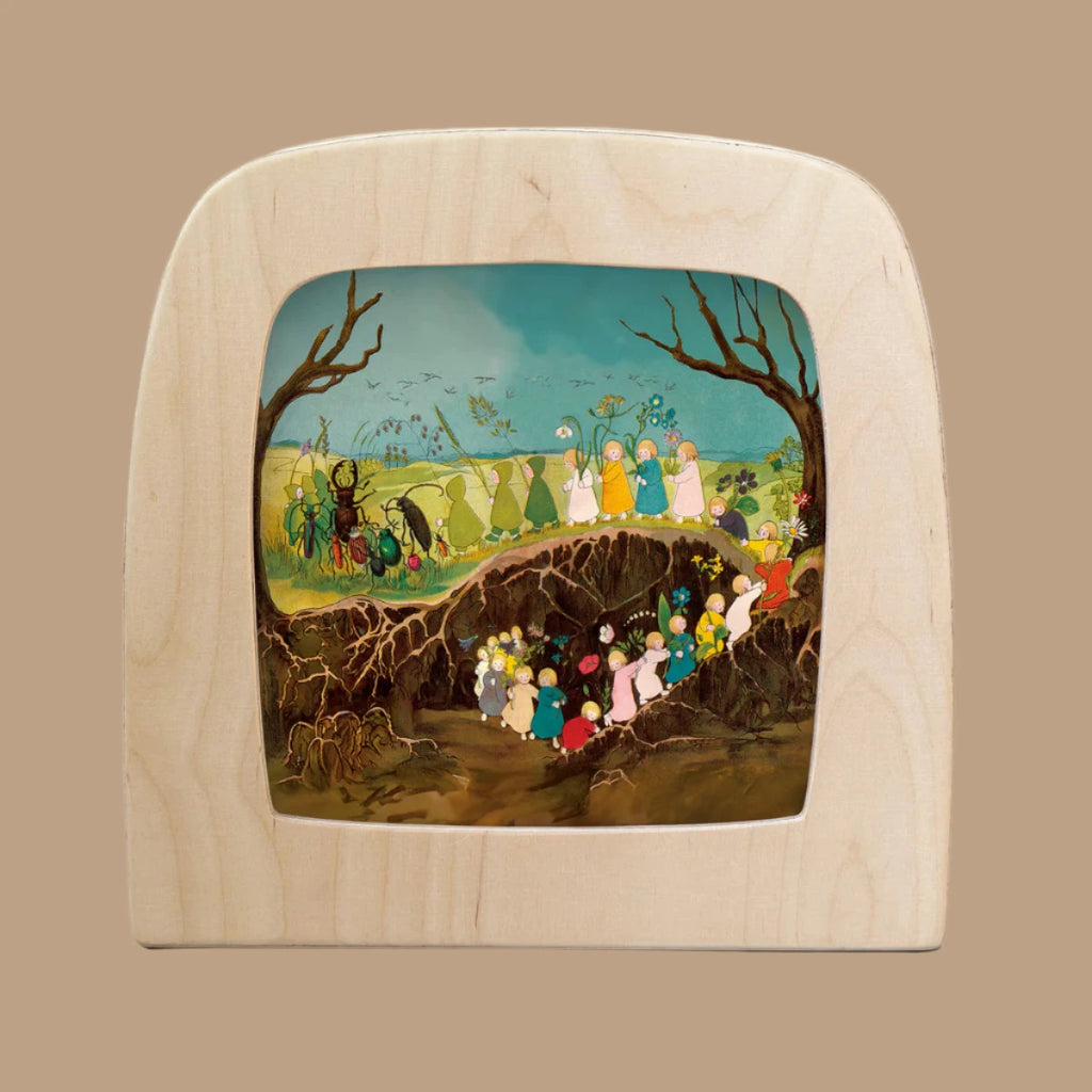 The Silhouette Only - The Story of the Root Children features colorful characters navigating a tree root in a serene forest under blue skies. This vibrant, ethereal scene enhances the enchanting glow of the Toverlux lamp.
