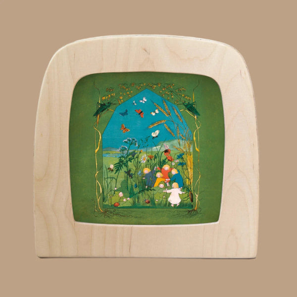 The "Silhouette Only - The Story of the Root Children Silhouette - Summer for Toverlux Lamp" features a whimsical illustration on wood, showcasing a vibrant garden with colorful mushrooms, butterflies, flowers, and a small white figure amidst lush greenery against a rich green backdrop.