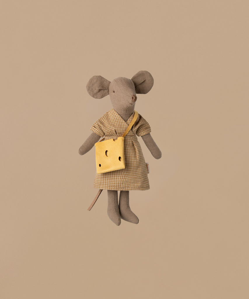 The Maileg Moms Afternoon Tea Set features a Mum Mouse in a checkered dress with a yellow cheese-shaped purse, displayed on a beige backdrop. Not for children under 3 years—small parts may pose choking hazards.