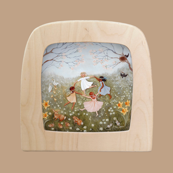 The "Silhouette Only - Spring Dance for Toverlux Lamp" features a wooden television-shaped frame with an illustration titled "Magic Silhouettes," depicting four children dancing in a flower-filled meadow, surrounded by birds and rabbits, against flowering trees, creating a serene home atmosphere.