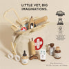 The Pretend Play Animal Vet Set features wooden medical tools, bottles, and accessories in a cream canvas bag with a red cross. Eco-friendly and perfect for career role play. "Little Vet, Big Imaginations." Bag dimensions included.