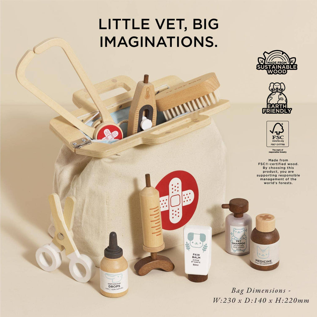 The Pretend Play Animal Vet Set features wooden medical tools, bottles, and accessories in a cream canvas bag with a red cross. Eco-friendly and perfect for career role play. "Little Vet, Big Imaginations." Bag dimensions included.
