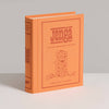 The Jenga Vintage Bookshelf Edition comes in an orange, book-shaped box with a line drawing of a Jenga tower—ideal for family game night, ages 6+, and one or more players.