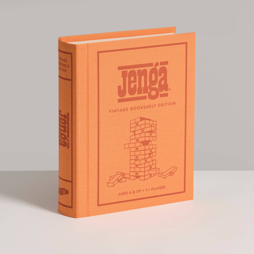The Jenga Vintage Bookshelf Edition comes in an orange, book-shaped box with a line drawing of a Jenga tower—ideal for family game night, ages 6+, and one or more players.
