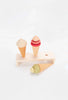 Two Handmade Ice Cream Cones and a toy popsicle, all coated with non-toxic water-based paint, displayed on a minimalist wooden stand against a white background.