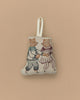 A charming Coral & Tusk Ice Skater Bears Ornament crafted from fabric, showcasing an embroidered design of two bears in vintage-style figure skating outfits. The bears are holding hands, and the ornament features a loop at the top for hanging. Its plain beige background makes it an ideal anniversary gift.