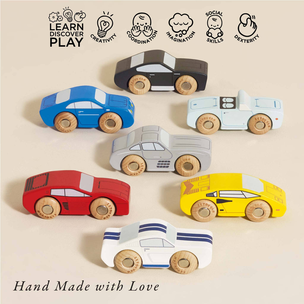 Classic Wooden Sports Cars in blue, red, yellow, gray, and white are displayed on a light surface. Made from FSC-certified wood, icons highlight benefits like creativity and coordination. Text reads "Hand Made with Love.