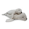 Two Senger Naturwelt Cuddly Animal - White Seal plush toys, crafted from organic cotton, rest on a white background. The smaller seal lies atop the larger; both feature black eyes and noses—ideal for use as snuggly warming pillows.