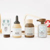 Four toy bottles from the Pretend Play Animal Vet Set—paw balm, ear drops, medicine, and pet shampoo—feature pastel colors and cute animal designs on white, inspiring career role play fun for young vets.